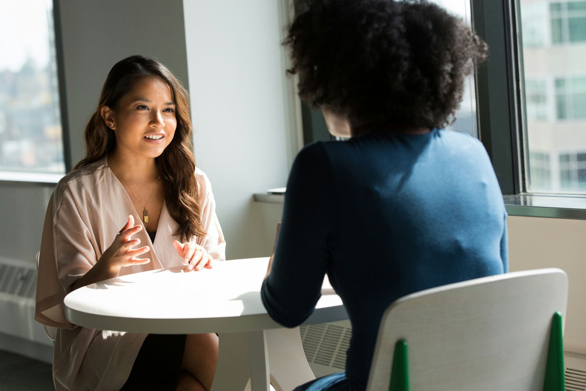 Two TRATON employees of diverse backgrounds engaged in conversation