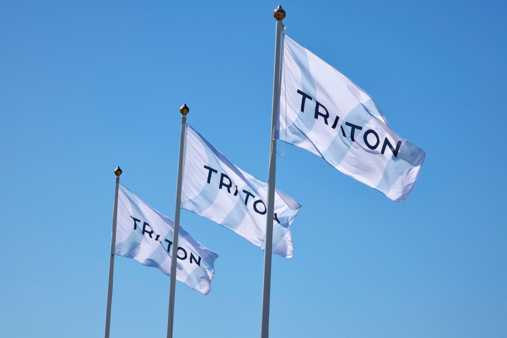 three company flags with the logo of TRATON
                 