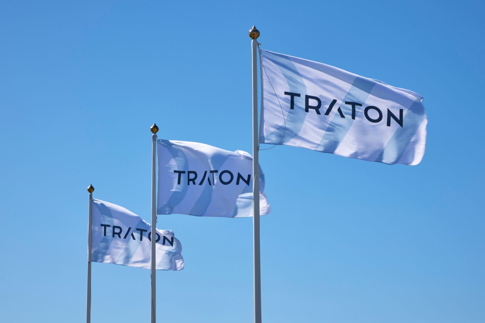three company flags with the logo of TRATON
                     