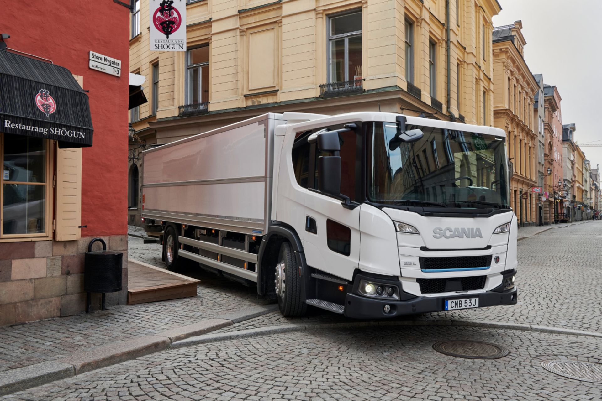 SCANIA Truck SCANIA truck drives in a small street in the old town of Stockholm