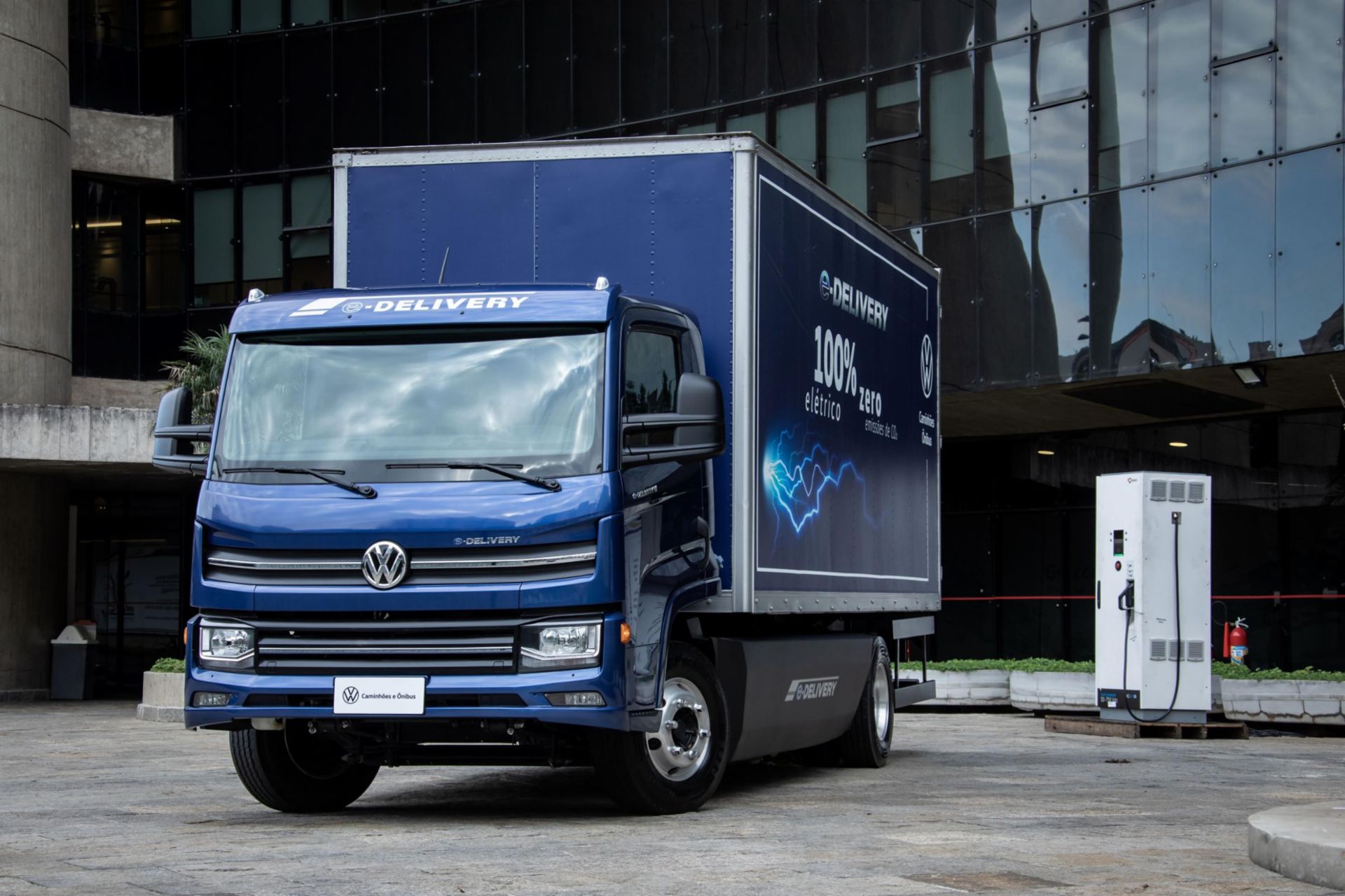 Blue Volkswagen truck next to a charging station