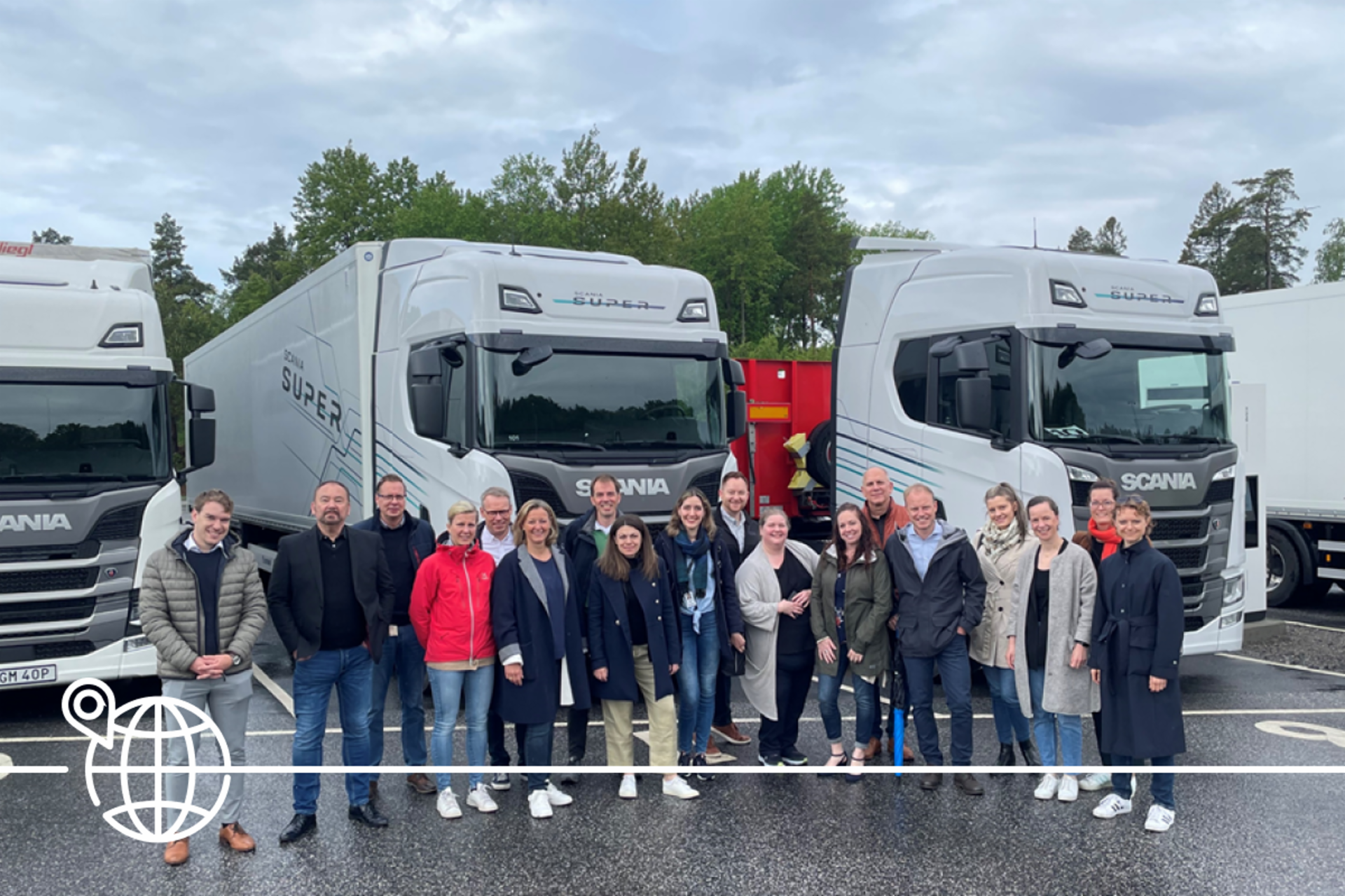 Group of perople in front of TRATON trucks